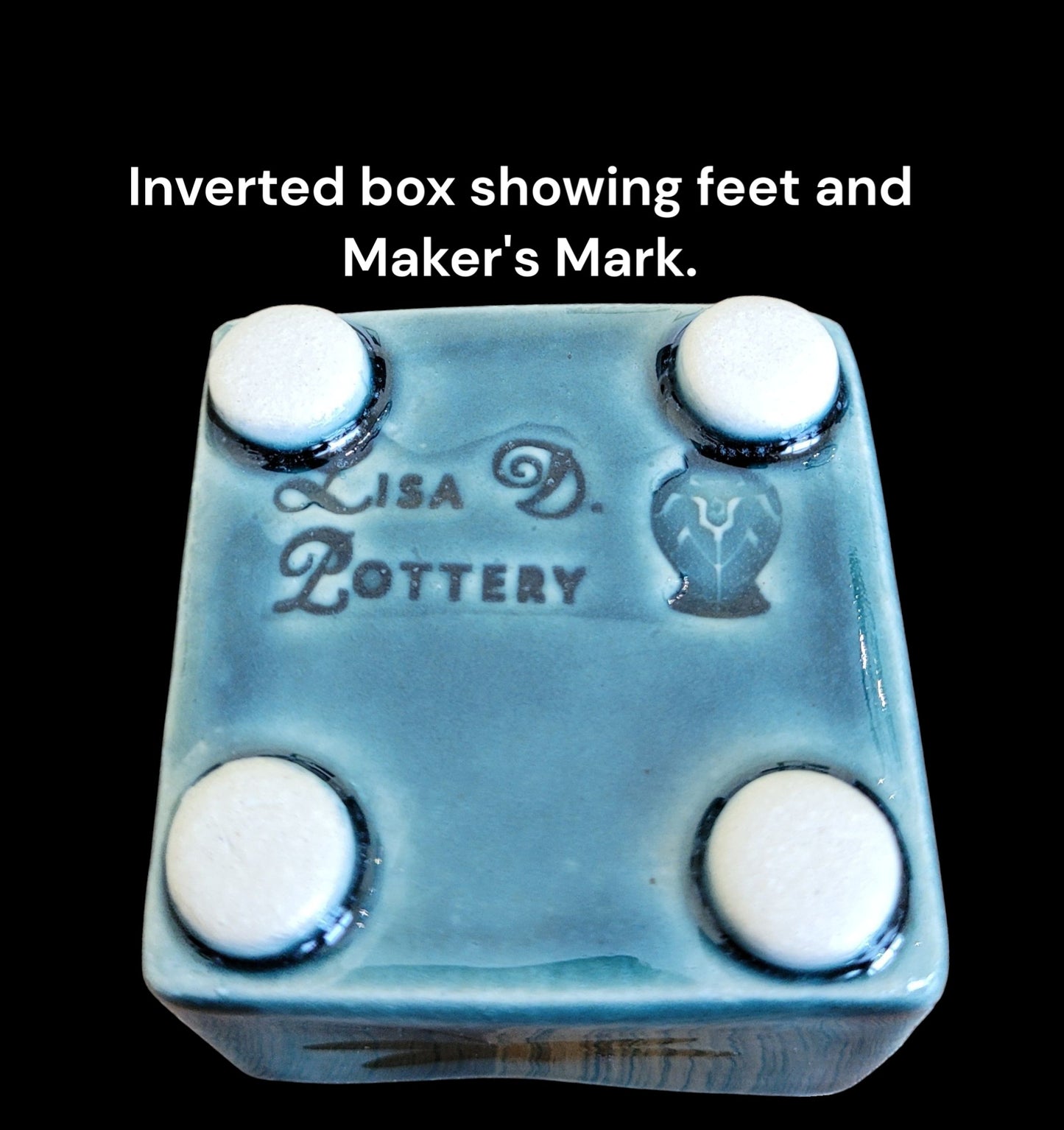 Inverted box showing feet and Maker's Mark Lisa D Pottery