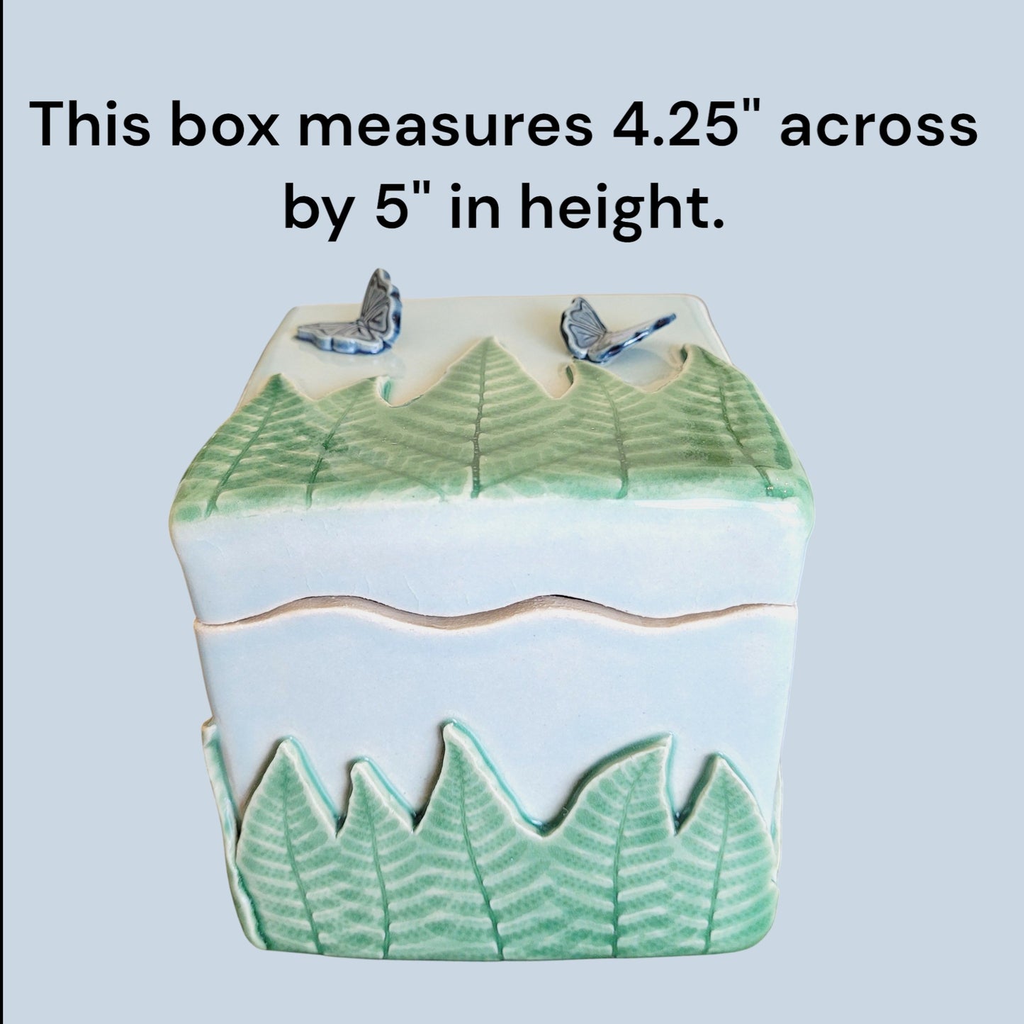 Decorative box with leaf patterns and butterflies on a light blue background showing box dimensions.