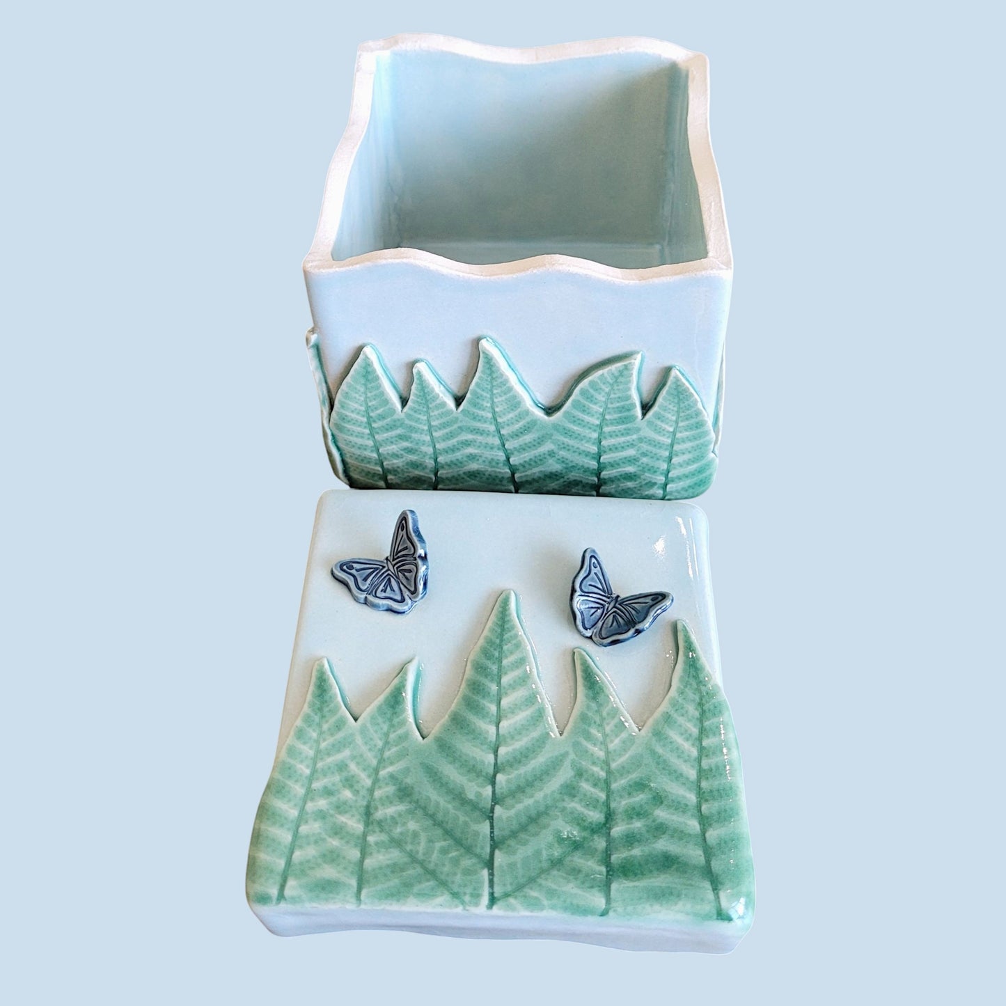 Inside and top view of ceramic box with fern and butterfly design