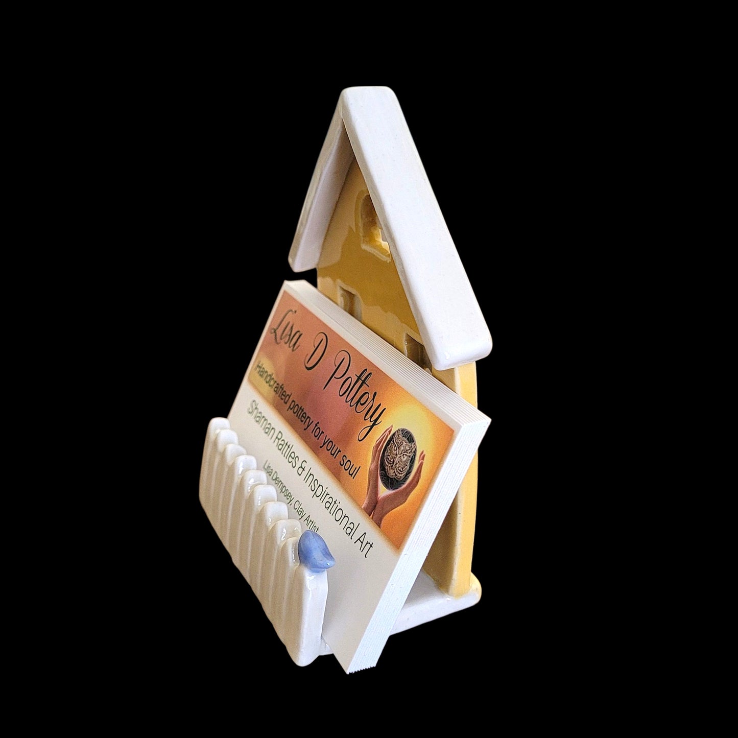 Decorative house-shaped card holder on a white background