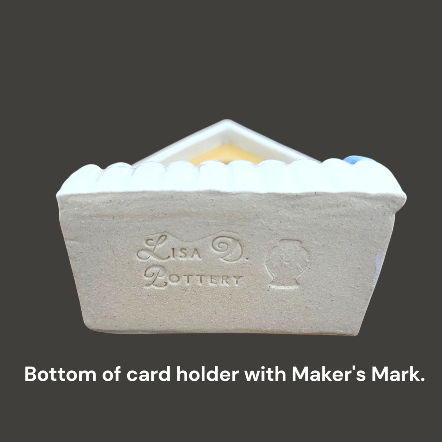 Card holder with 'Lisa D Pottery' branding on a dark background