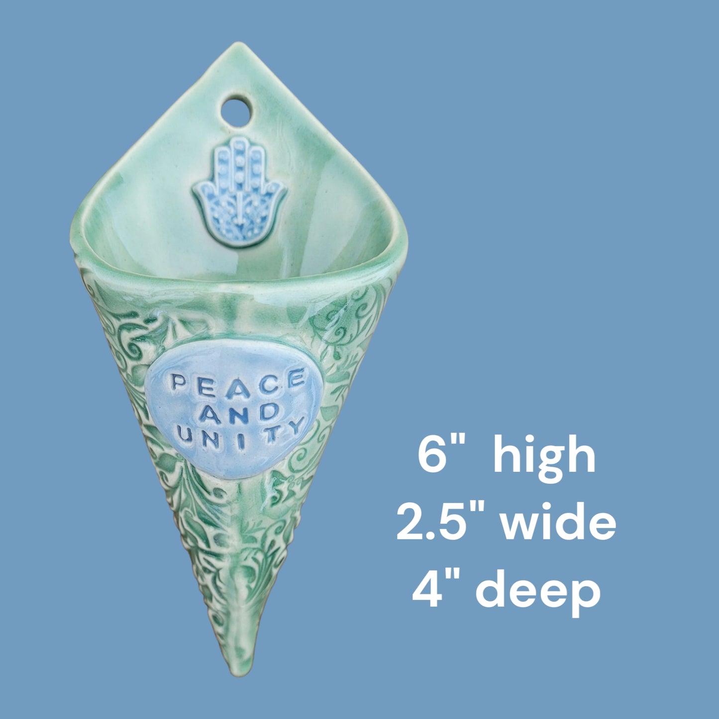 Green decorative wall hanging with 'Peace and Unity' text on a blue background showing measurements