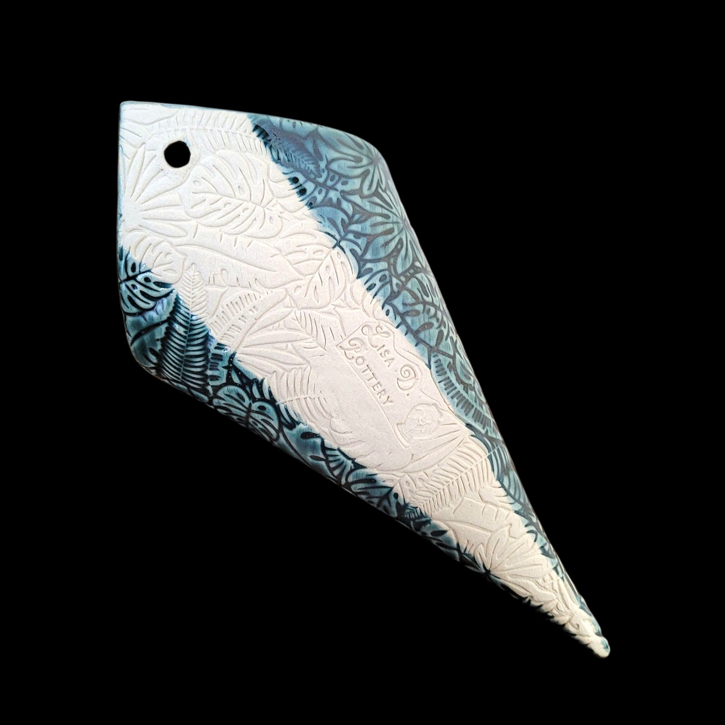 Reverse side of decorative wall pocket showing Marker's Mark of Lisa D Pottery on a black background