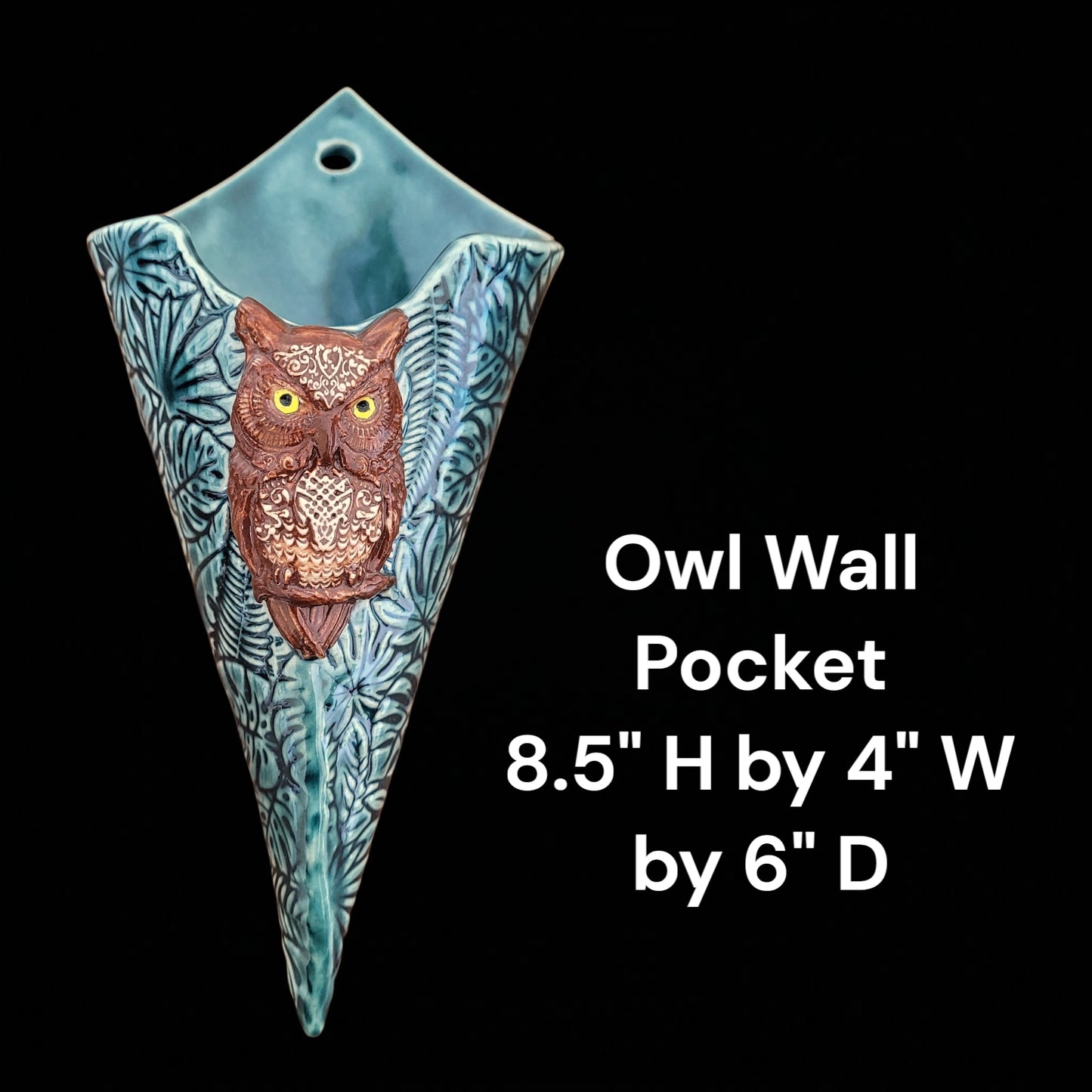 Cone shaped owl wall pocket with dimensions on a black background