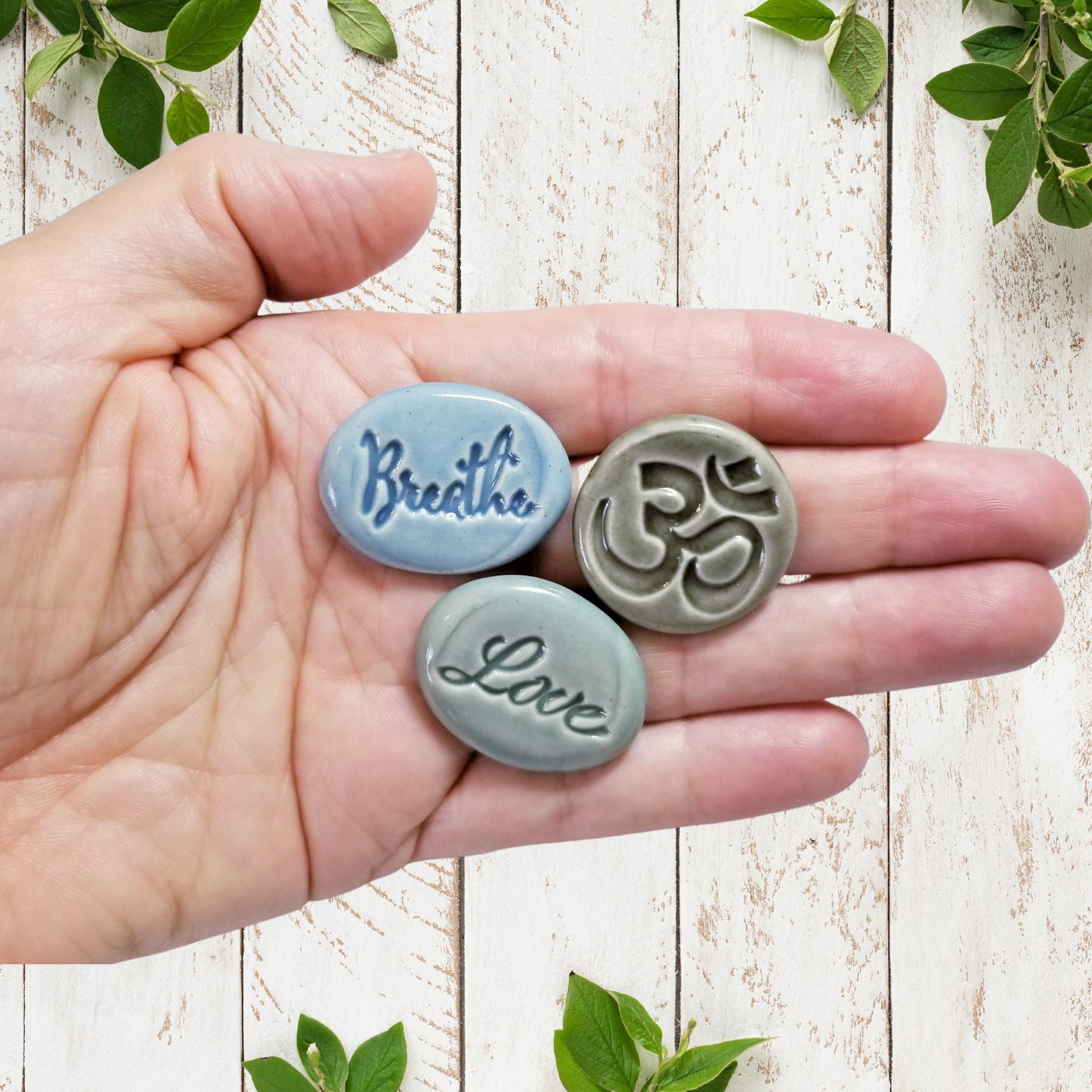 View of word stones in hand for size reference
