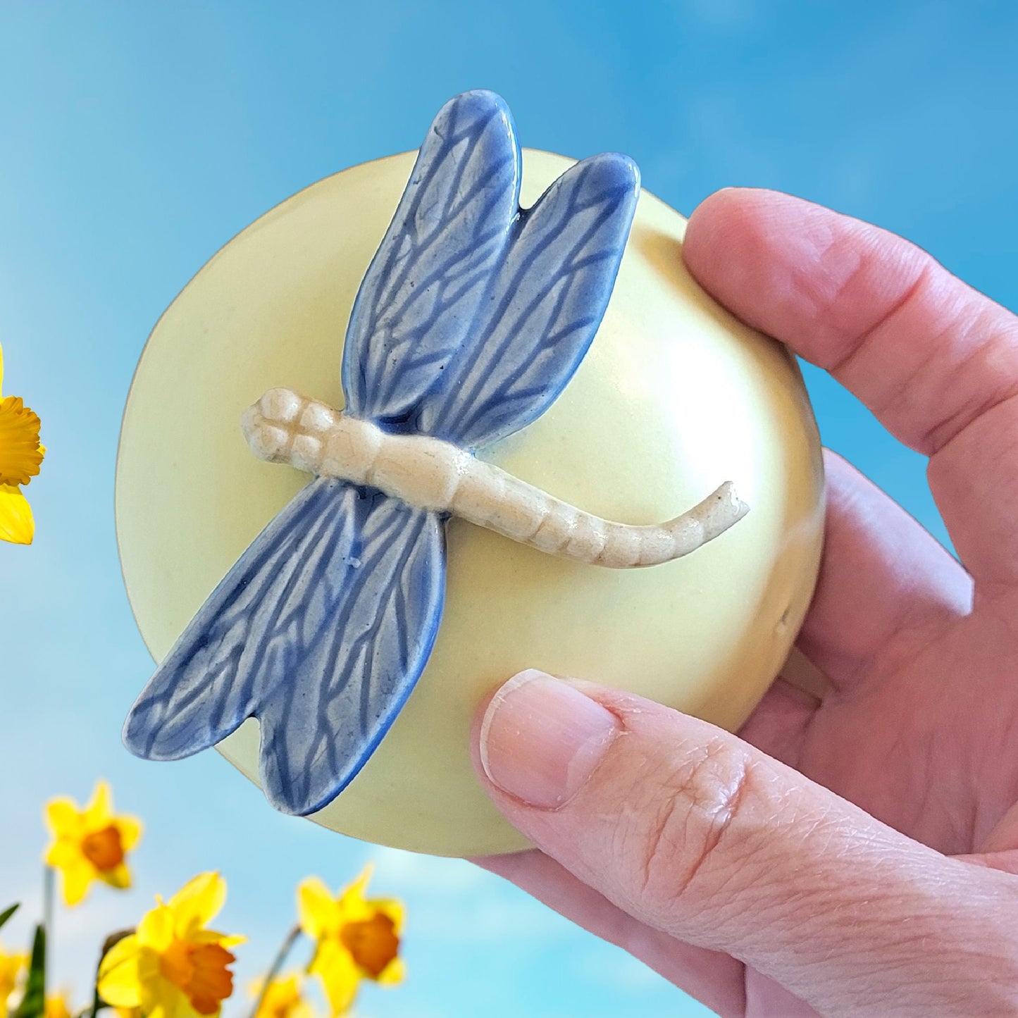 Handcrafted dragonfly meditation rattle held in hand showing size