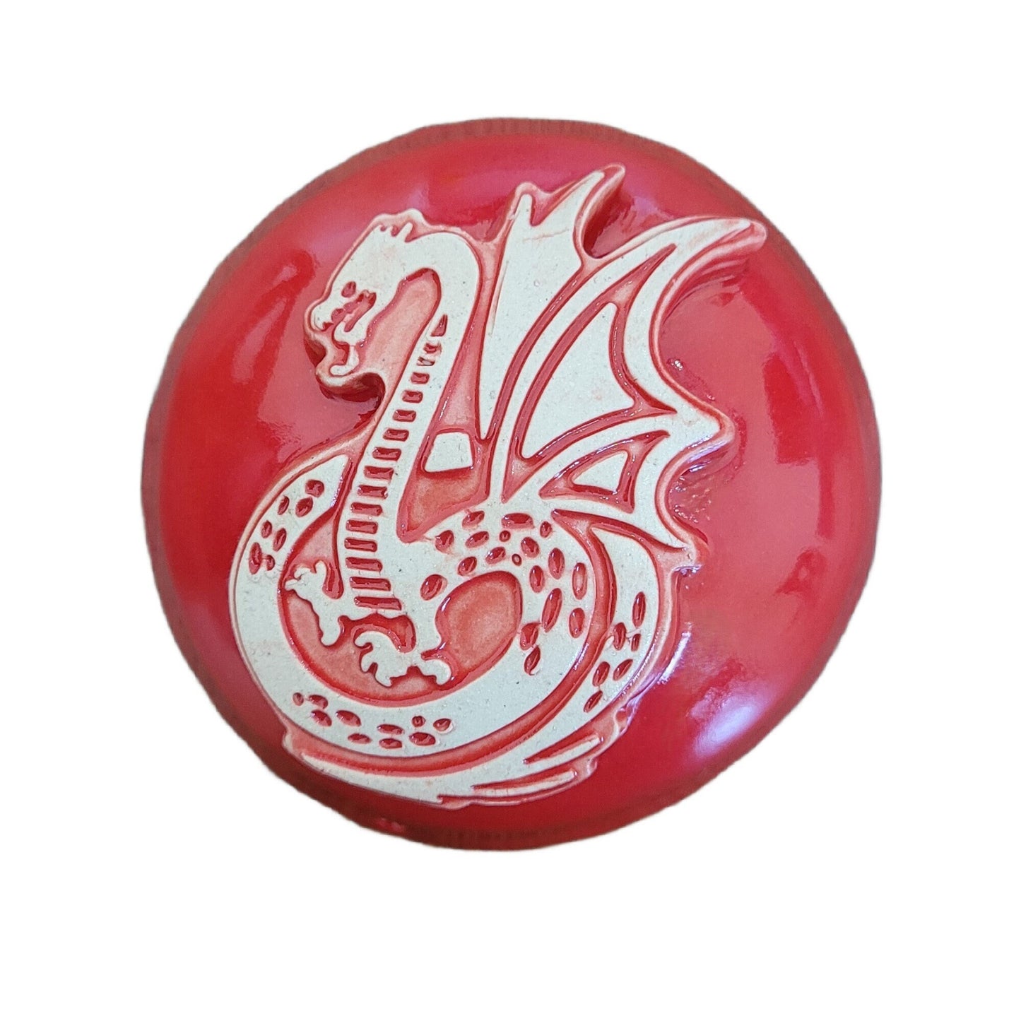 Red dragon meditation rattle with detailed scales and flowing curves, handcrafted from stoneware clay with glossy glaze finish