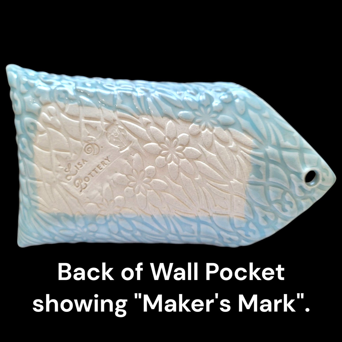 Back of a wall pocket with embossed design and 'Maker's Mark' text on a black background