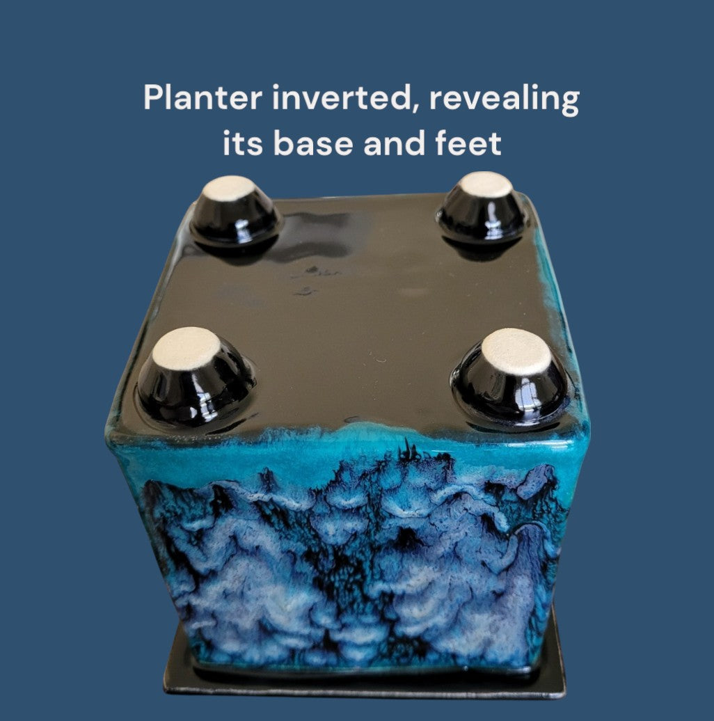 Inverted planter showing its base and feet on a blue background