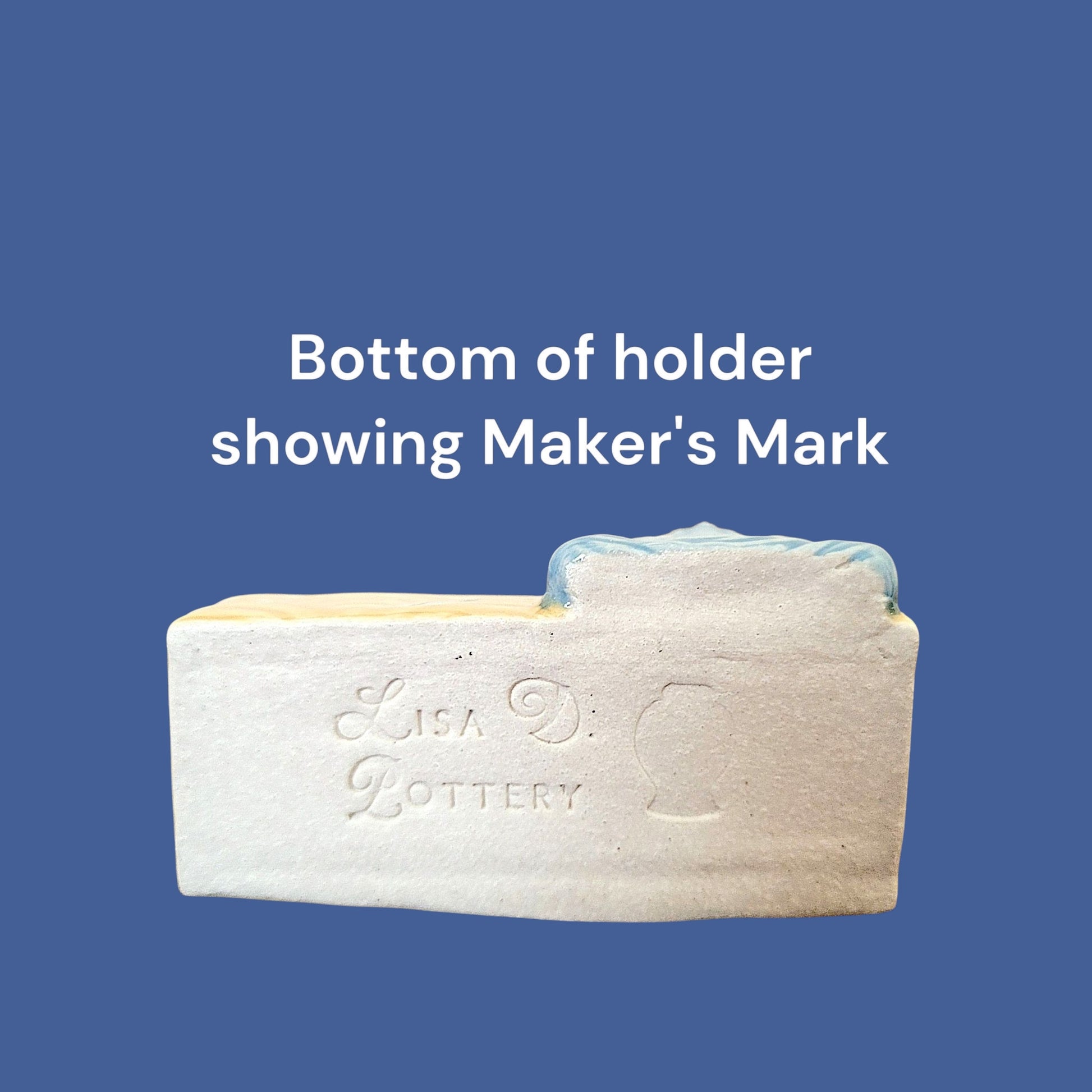 Bottom of ceramic business card holder with 'Maker's Mark' Lisa D Pottery on a blue background