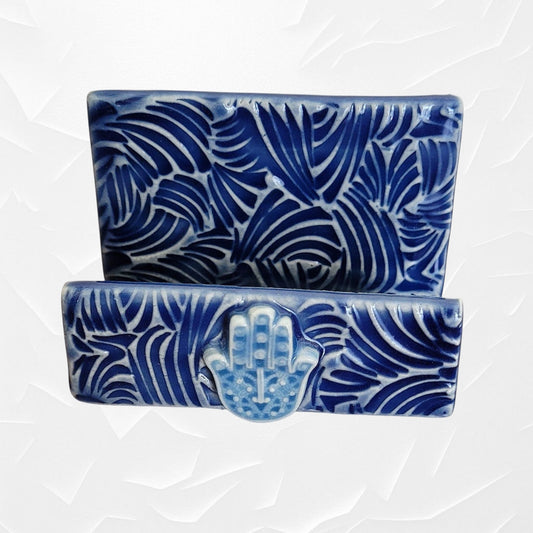 Blue and white business card holder with a light blue hamsa hand.