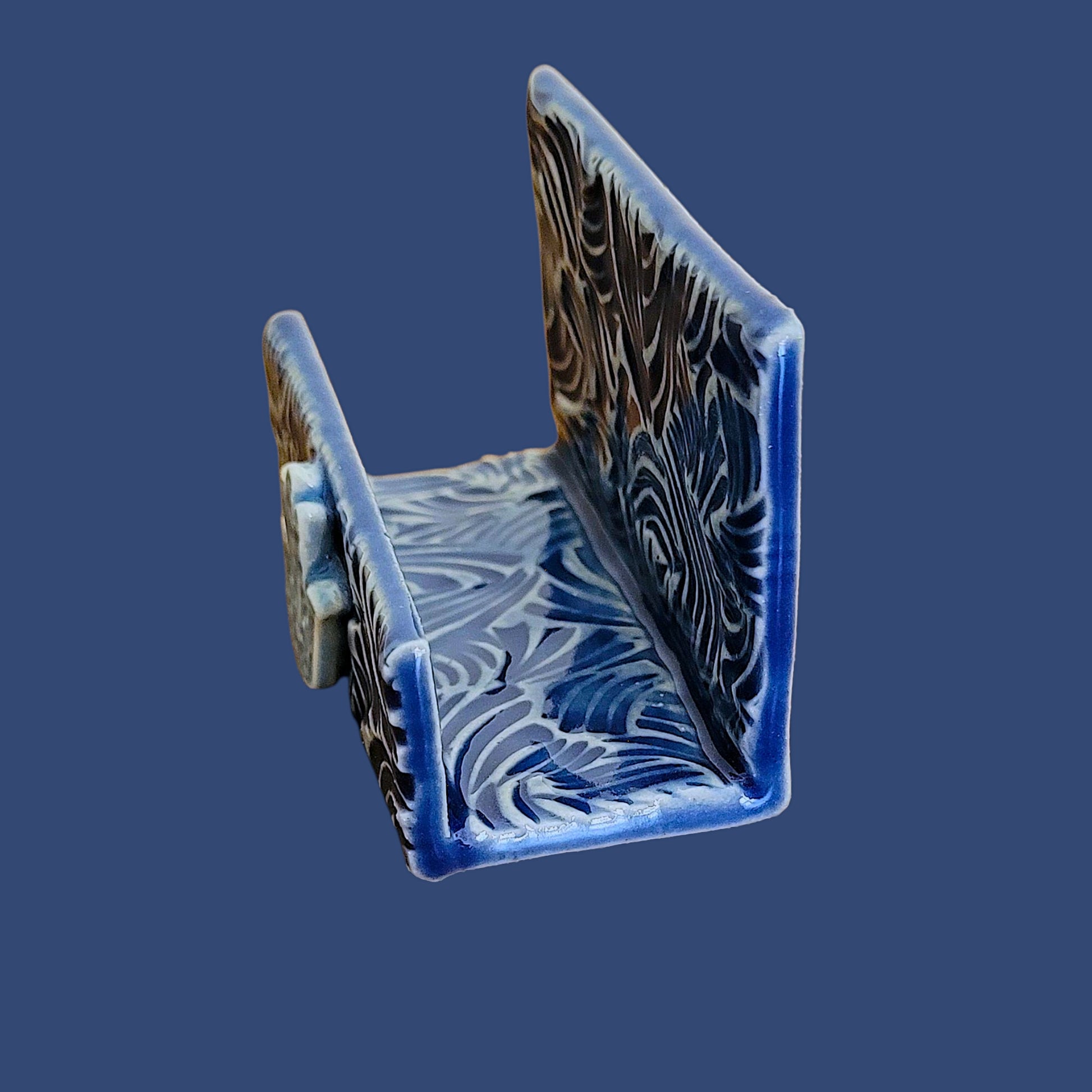 side view of hamsa hand business card holder showing textured blue surface