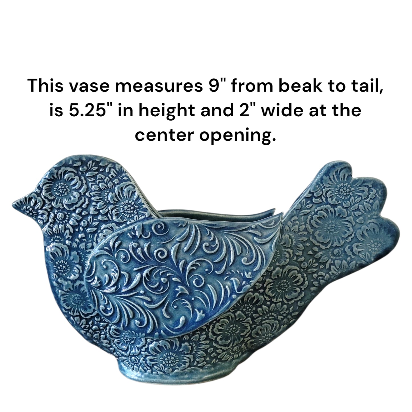 Blue ceramic bird-shaped vase with decorative patterns and dimensions on a white background