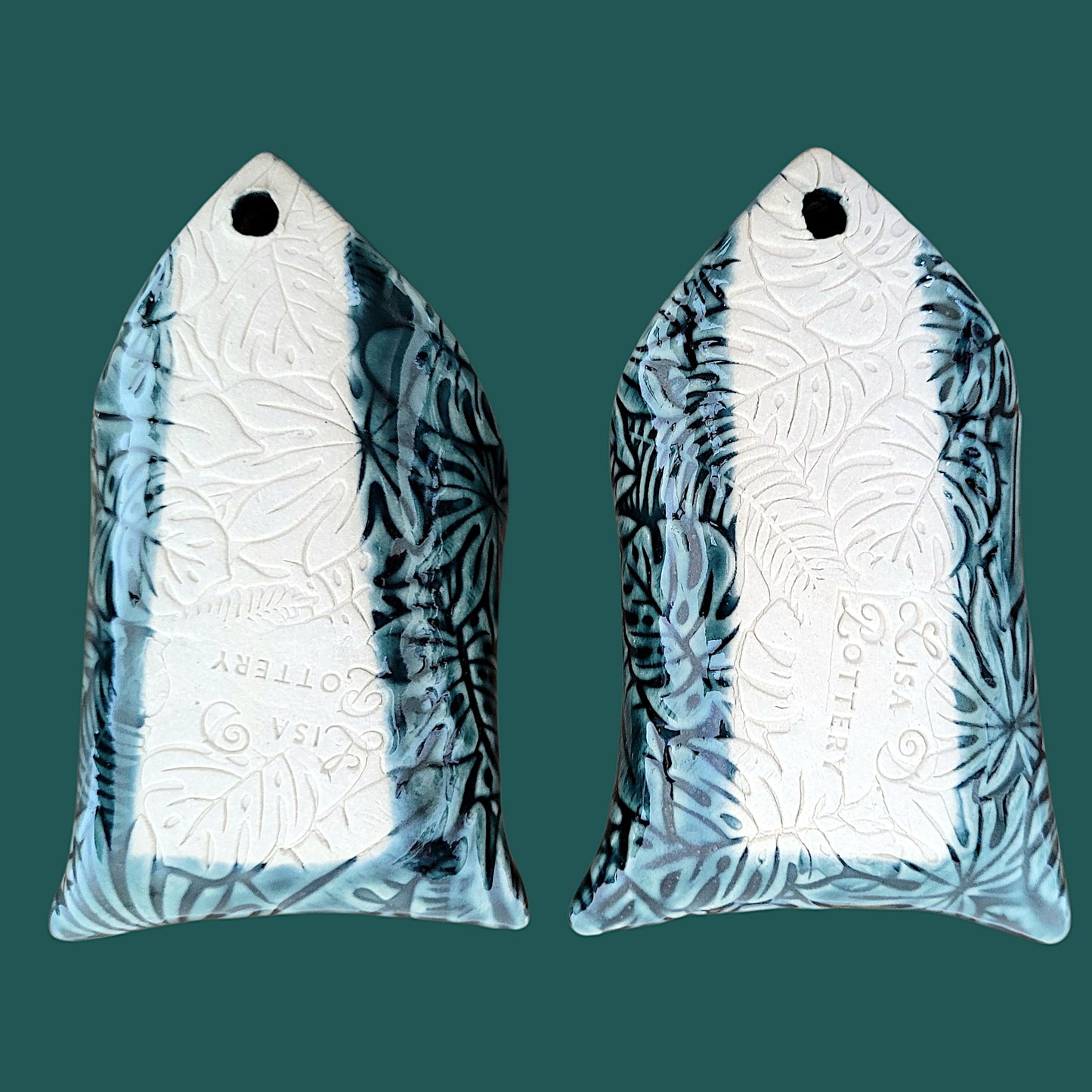 Reverse side of 2 wall pockets showing the Lisa D Pottery "Maker's Mark"