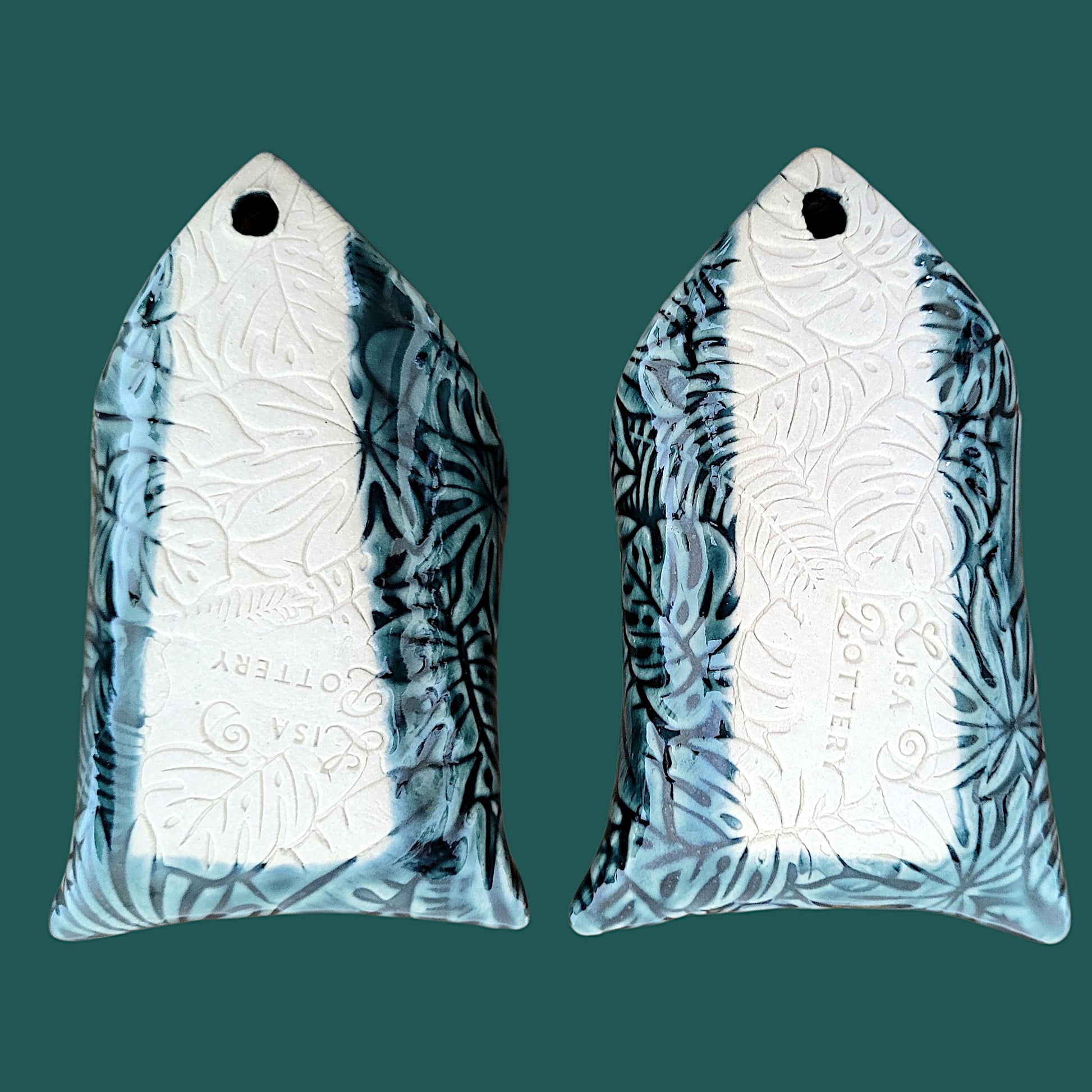 Reverse side of 2 wall pockets showing the Lisa D Pottery "Maker's Mark"