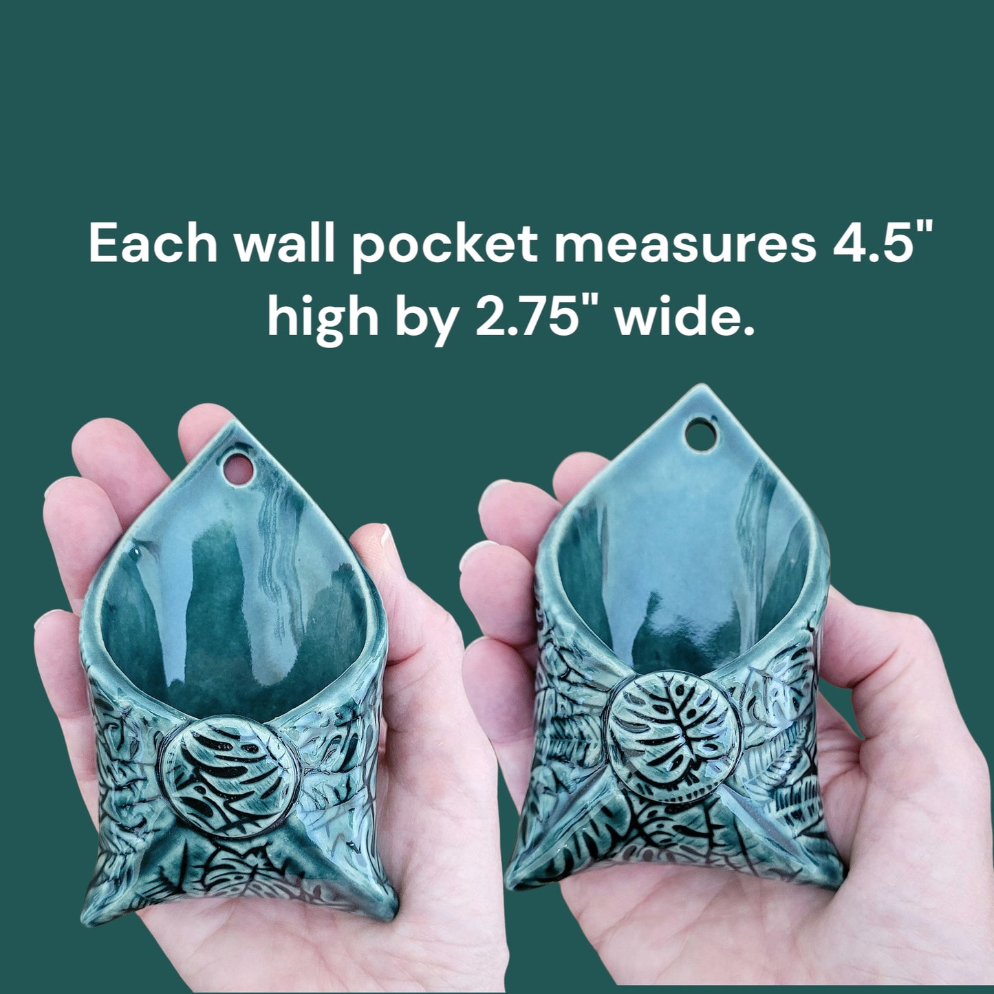 Two dark green wall pockets held in hands with text indicating dimensions.